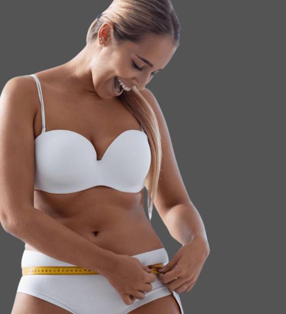 woman in white bra and underwear measuring her waist woman in white bra and underwear measuring her waist